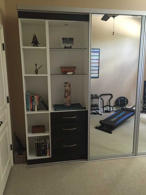 Hybrid room for both fitness work out room and guest room with Murphy bed behind mirror