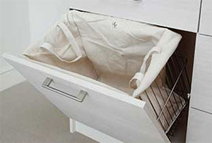 Clever laundry hamper design in custom closets help keep everything organized.
