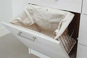 Tilt-out hamper in closet organizer.