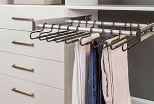 Slide out pant racks in custom closets make it easy to access your clothing.