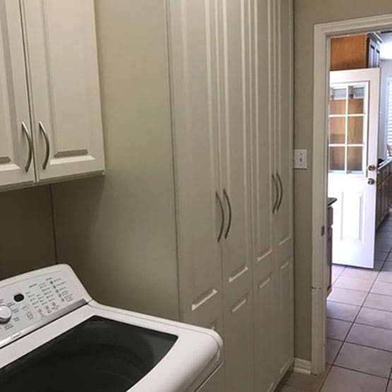 Modern space saving laundry room with custom linen cabinets