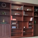 brow book case with vase flowers and books