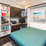 home office with a bed pull out area and decor in the shelves to the side
