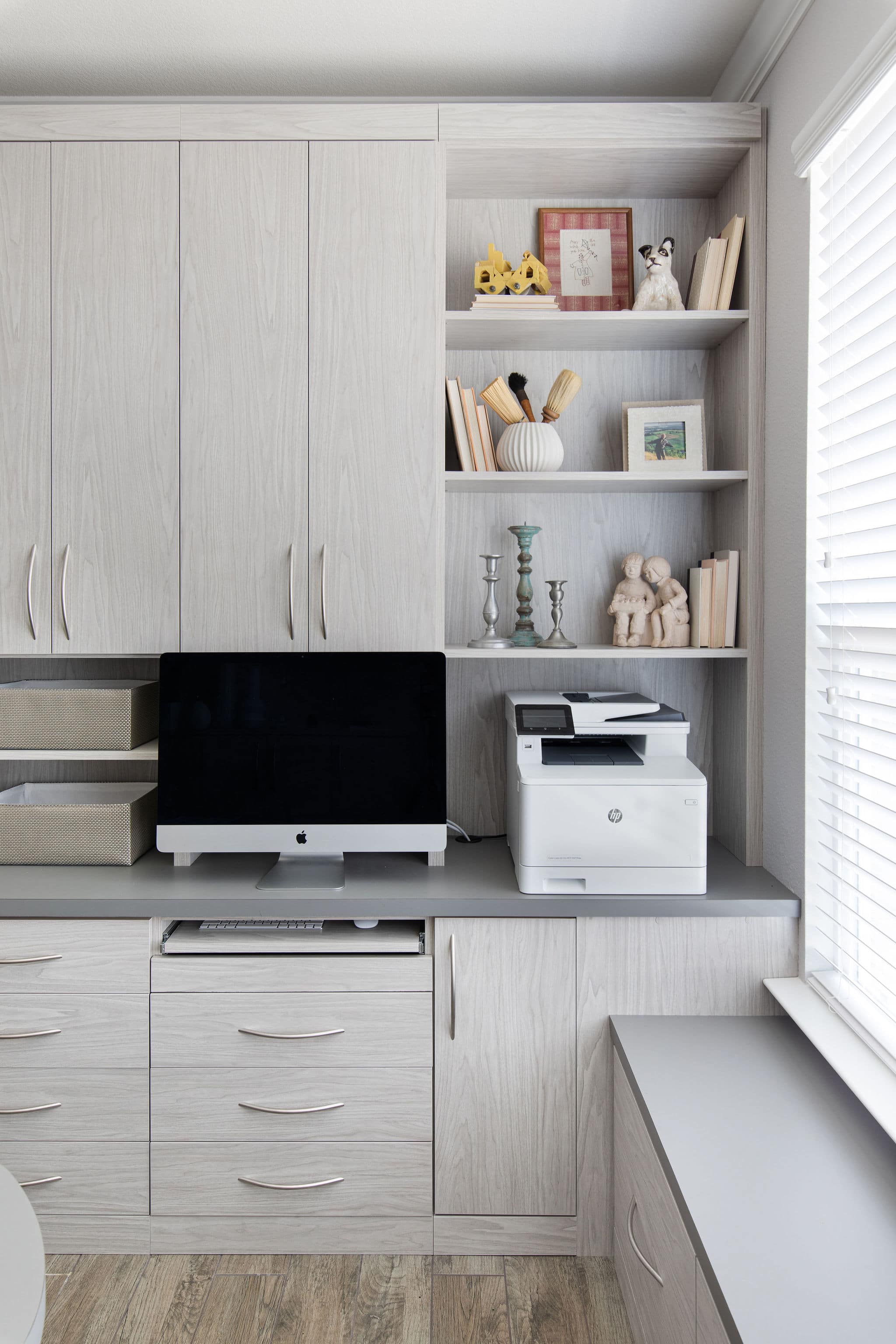 A home office space with a pull-out keyboard drawer and room for computer and printer