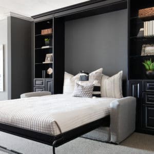Sophisticated space saving Murphy bed between modern custom black wooden cabinets.