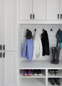 Light and bright open closet for coats, boots and more.