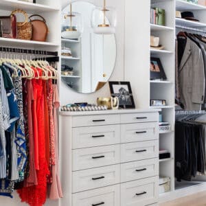 A custom closet system with drawers and a vanity for close organization.