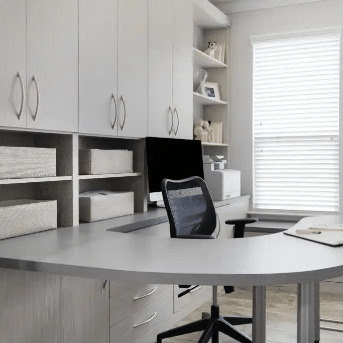 Home office in weekend getaway with curved desk and bench seating.