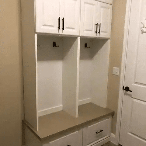 White traditional mudroom with drawers below and cabinets on top.