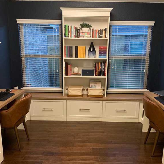 Home office in white shaker with a bench.