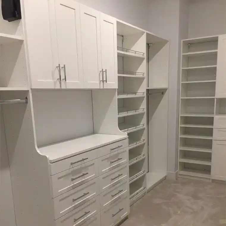 White shaker closet with wardrobe lifts and shoe shelves.