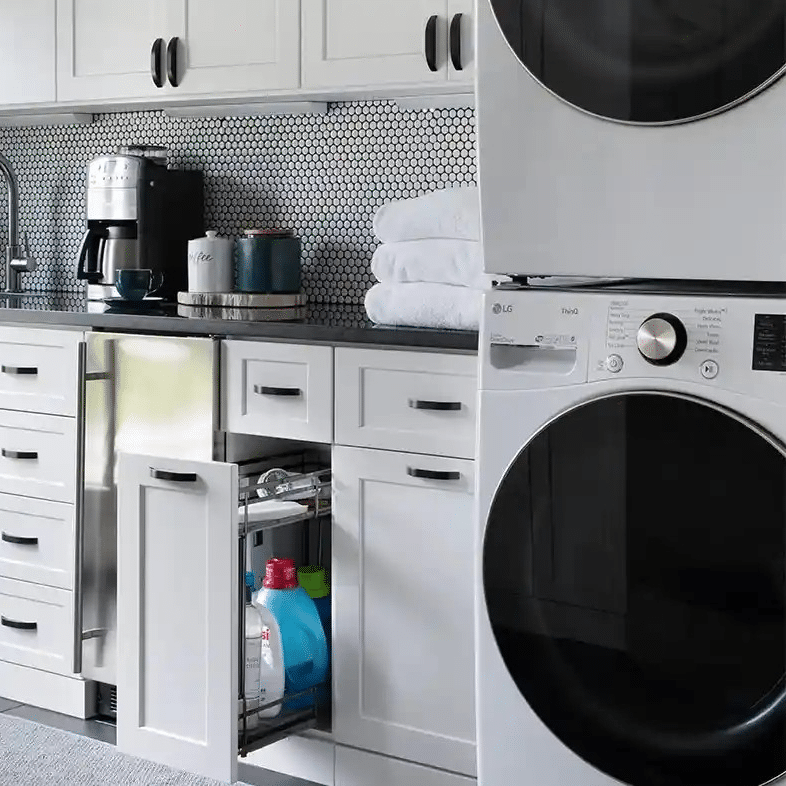 White shaker utility room with glide out cabinet.