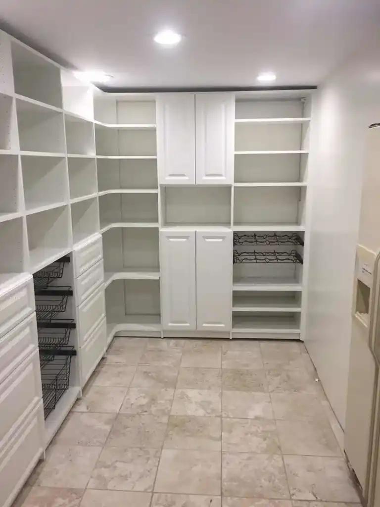 White traditional pantry with baskets and some closed storage.