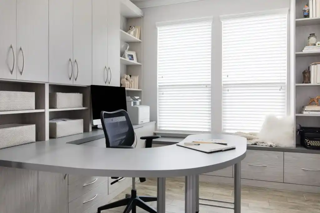 Home office in weekend getaway with curved desk and bench seating.
