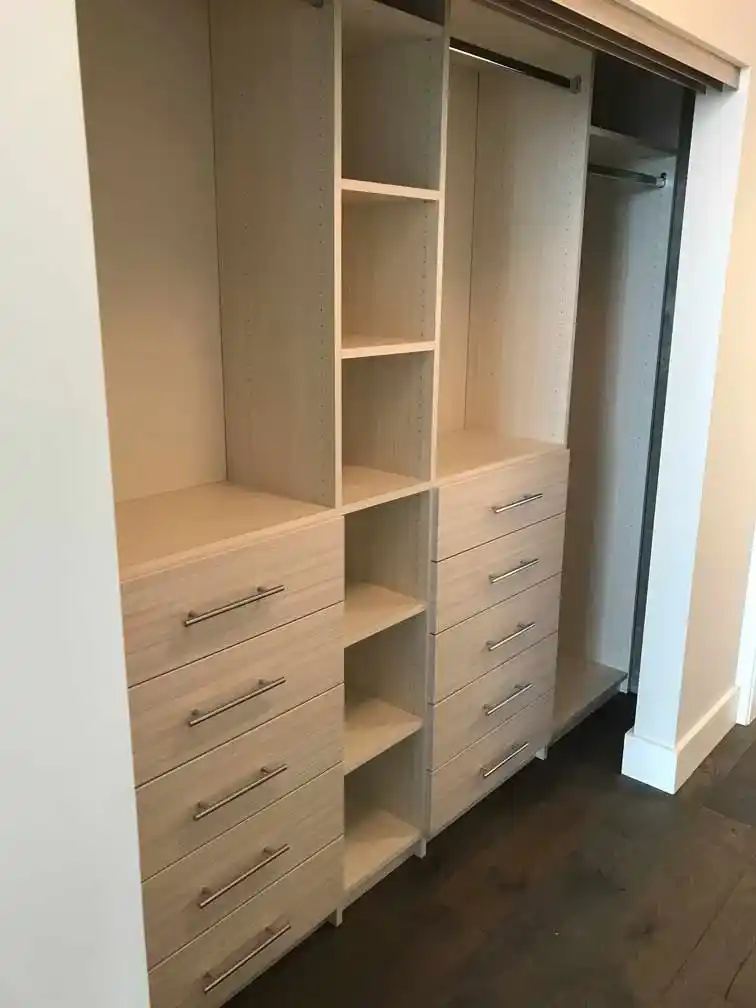 Reach in closet in white chocolate with drawers, shelves, and hanging.