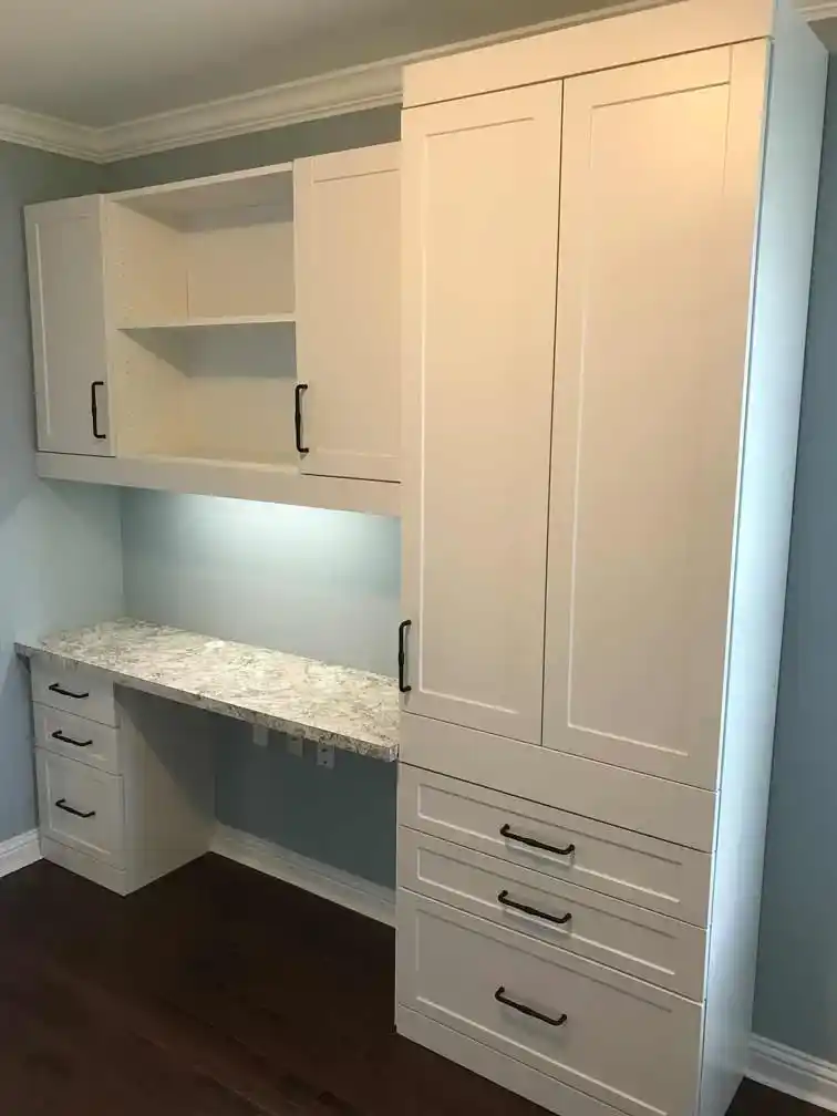 White shaker home office with task lighting and drop-down table.