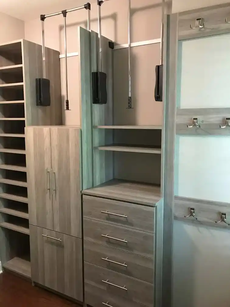 Summertime blues closet with wardrobe lifts and hooks.