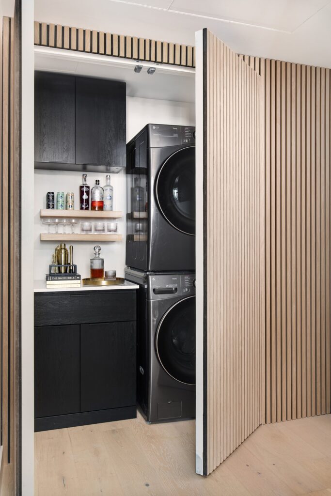Custom storage cabinets allowed a built-in bar in the laundry area for hosting clients and entertaining prospects.